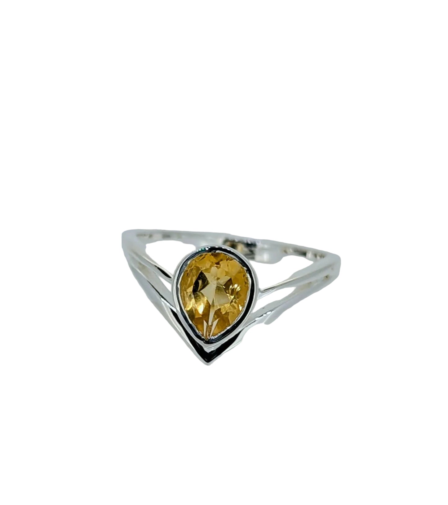 A radiant faceted teardrop citrine ring glows from within a sculptural high-sided sterling silver setting