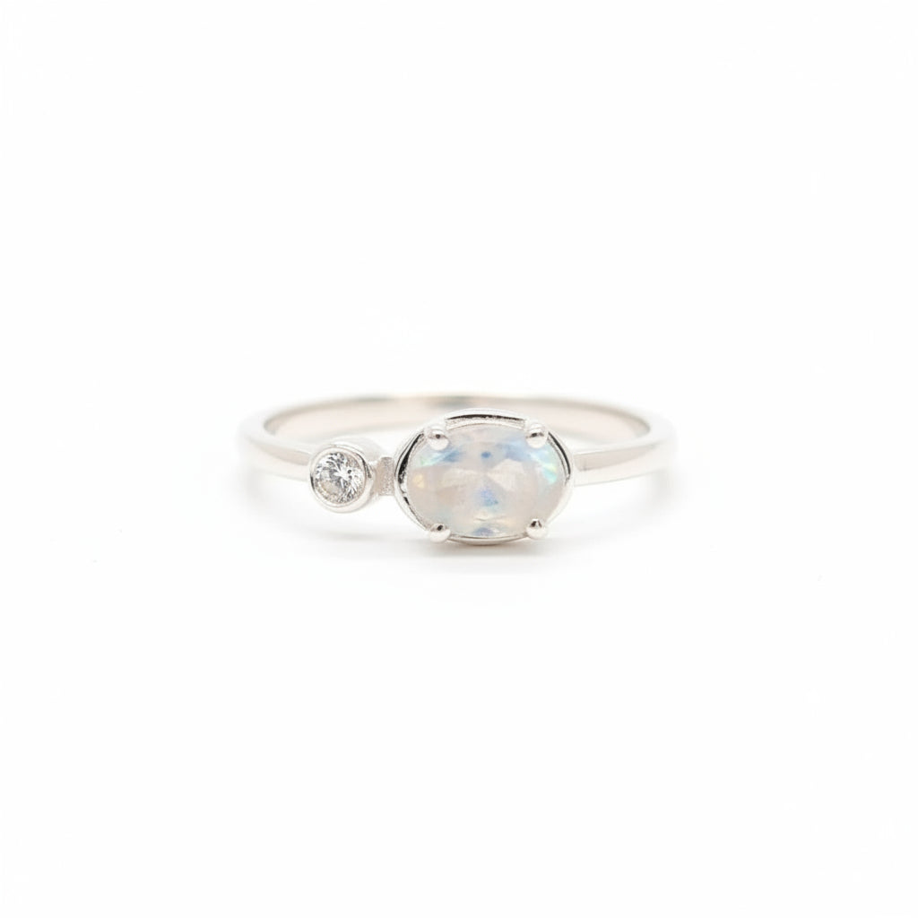 Rainbow moonstone held in a fine claw setting with a tiny zirconia on the side - Set in sterling silver thin curved band