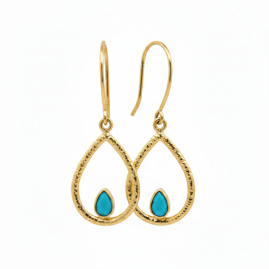 Hook swing earrings with a petite turquoise gem nestled in a warm gold-over-brass teardrop shape