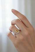 A radiant faceted teardrop citrine ring glows from within a sculptural high-sided sterling silver setting