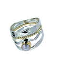 This exquisite ring features a luminous button pearl nestled gracefully at the centre of a woven web of sterling silver and a subtle touch of gold.