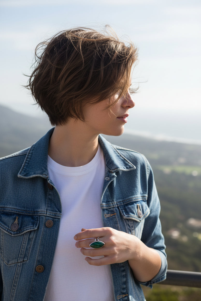 Malachite gem sits in a silver pond above a stylish split shank band in this bold contemporary ring