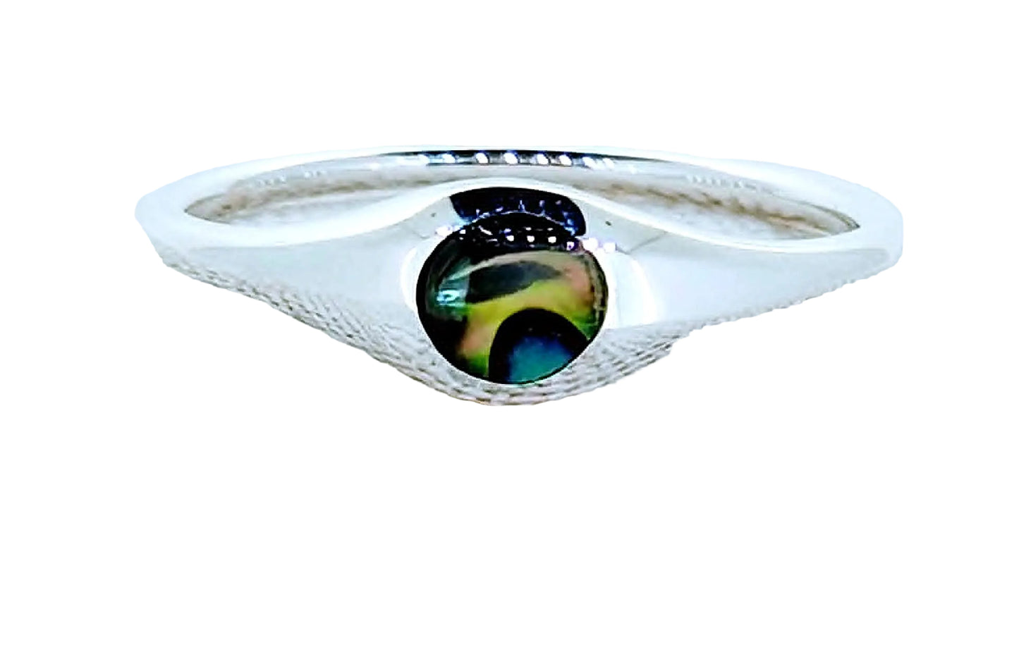 Silver ring with a colorful stone on a textured white surface