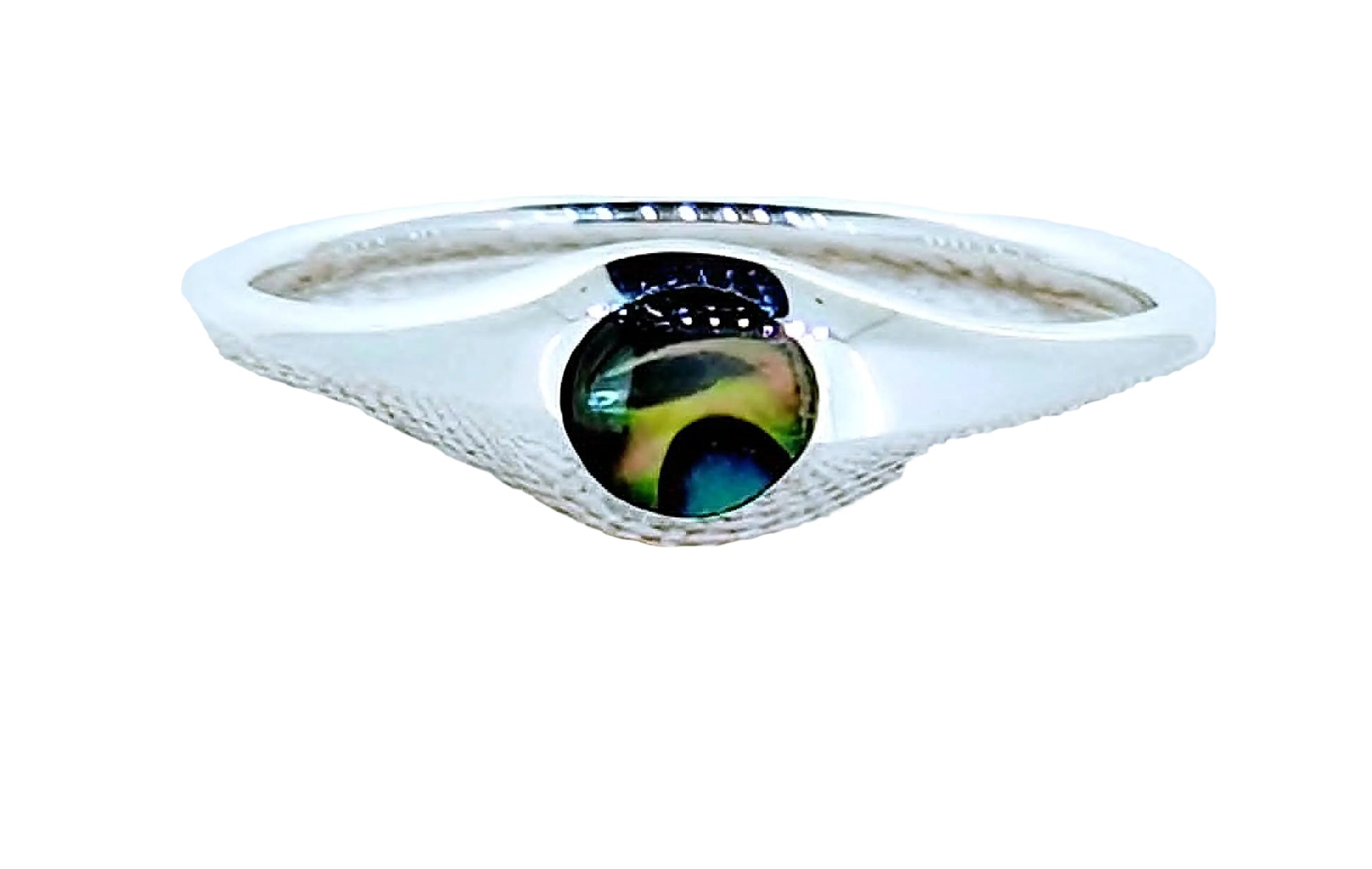Silver ring with a colorful stone on a textured white surface