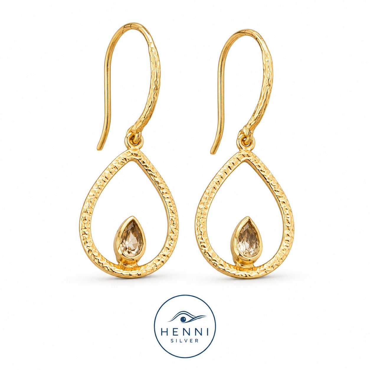 Hook swing earrings with a petite turquoise gem nestled in a warm gold-over-brass teardrop shape