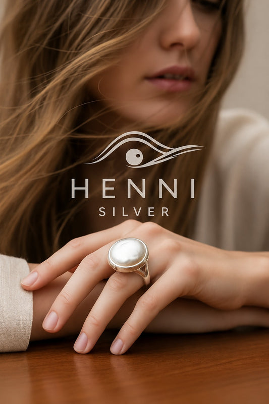 Luminous baroque pearl set in sterling silver with a graceful split band — beautifully unique