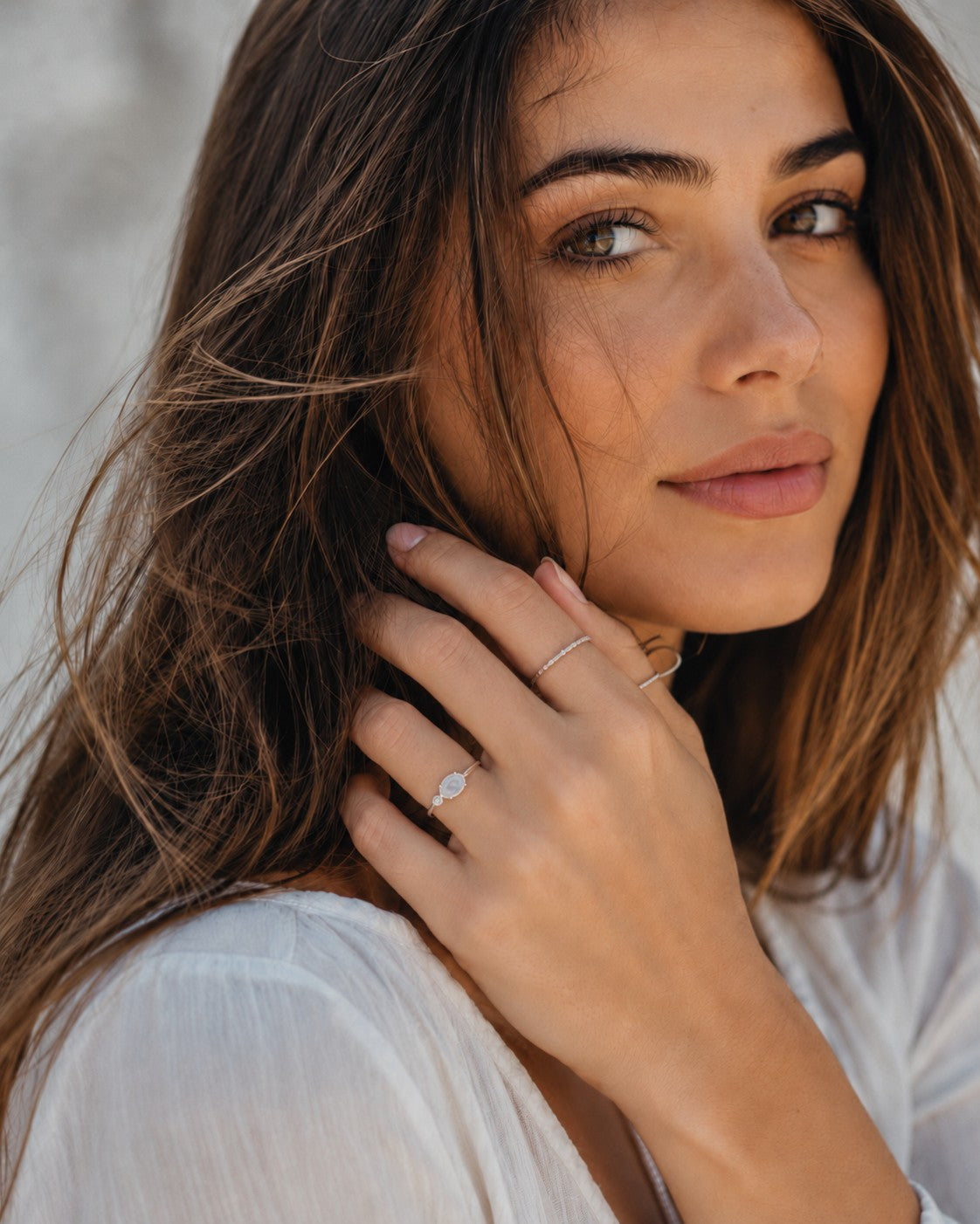 Rainbow moonstone held in a fine claw setting with a tiny zirconia on the side - Set in sterling silver thin curved band