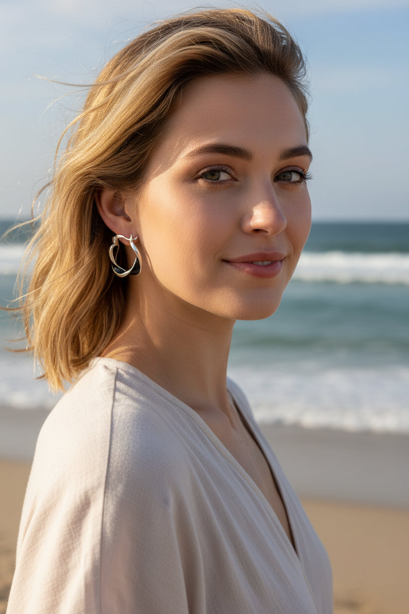 Pair of silver hoop earrings on a light gray background