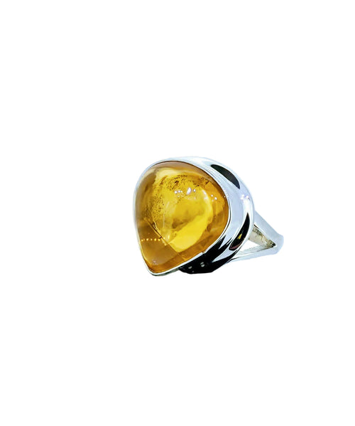 A striking statement ring featuring a glowing teardrop citrine cabochon set in polished sterling silver