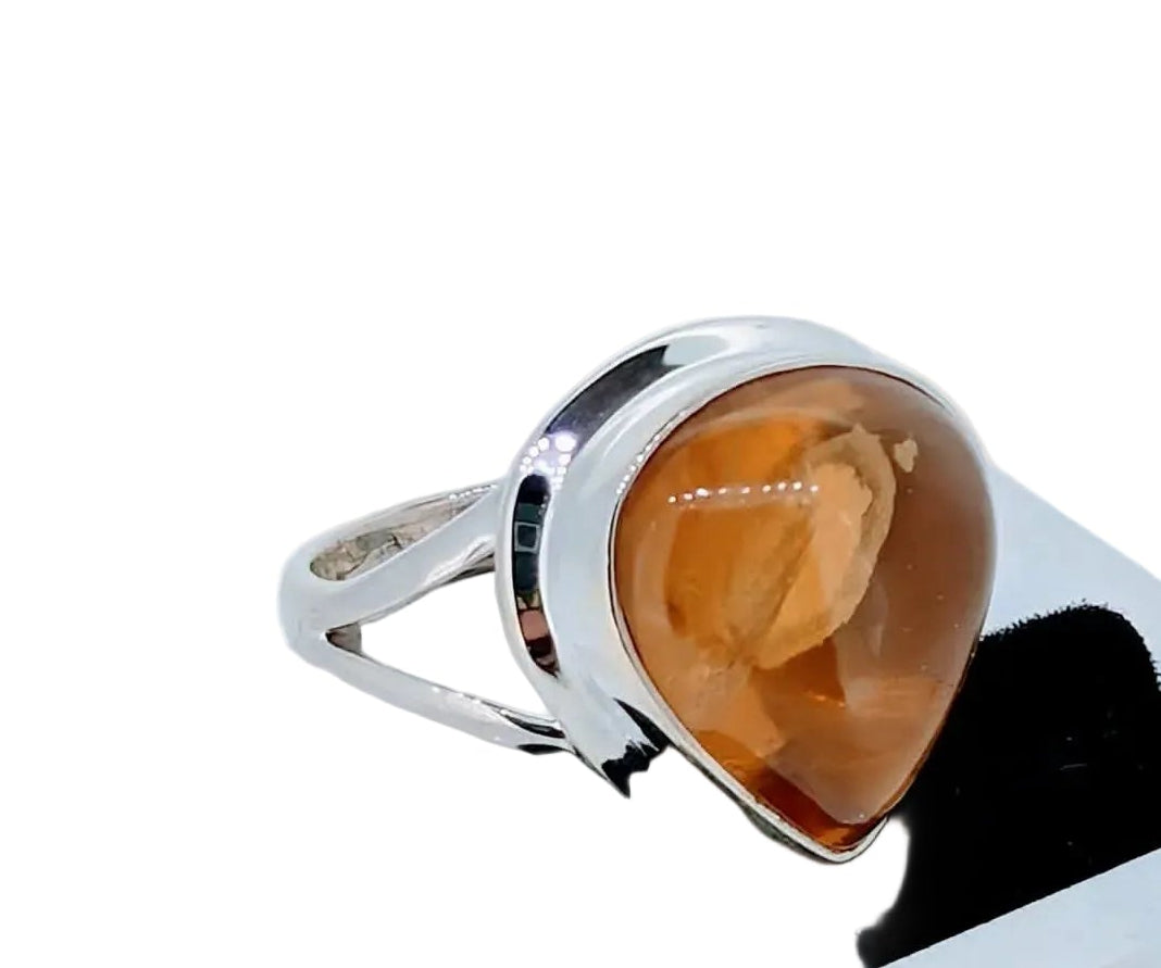 A striking statement ring featuring a glowing teardrop citrine cabochon set in polished sterling silver