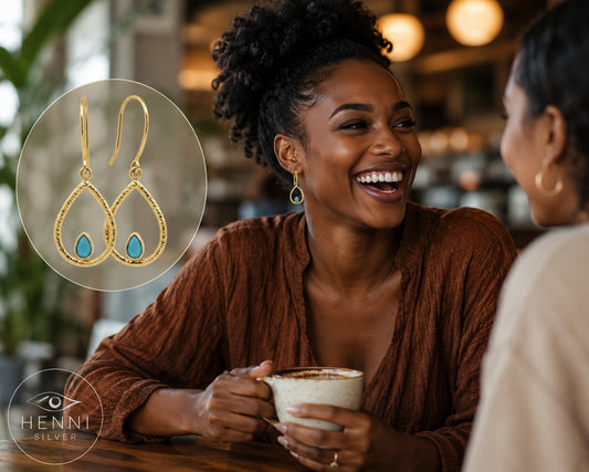 Hook swing earrings with a petite turquoise gem nestled in a warm gold-over-brass teardrop shape