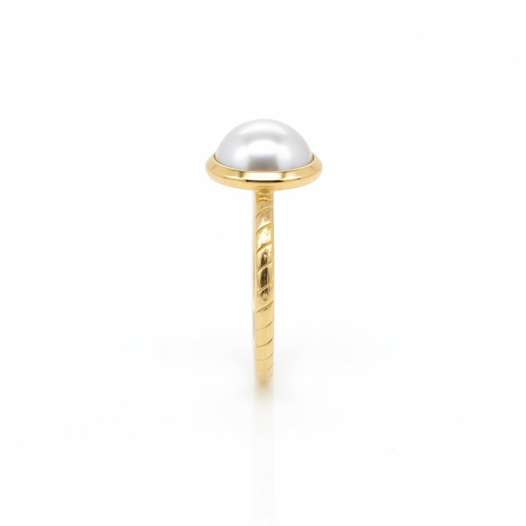 Gold ring with a pearl on a white background